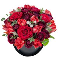 Roses and pion-shaped tulips in a box.