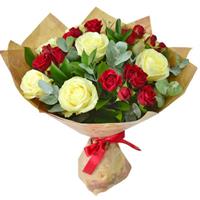 Delicate bouquet of white roses and red bush roses