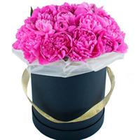 Bright composition in a box with 15 peonies