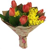 Bright bouquet of tulips and mimosa