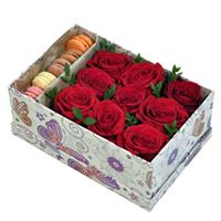 Box with red roses and macaroons